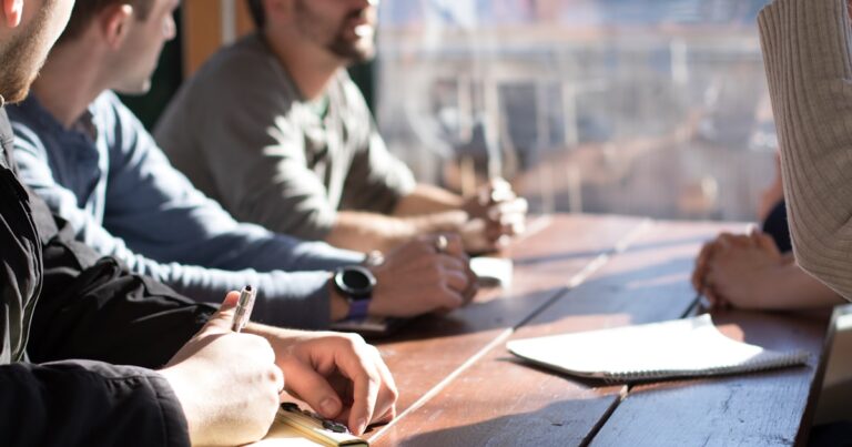 A team seated around a table in a meeting
